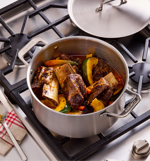 Braised beef short ribs with vegetables in Misen stainless steel pot on gas stove